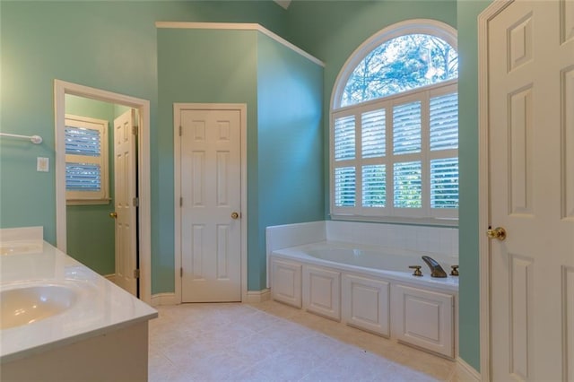 bathroom with a bath, healthy amount of natural light, and tile patterned floors