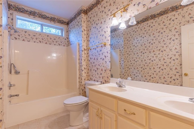 bathroom featuring wallpapered walls, toilet, tile patterned floors, double vanity, and shower / washtub combination