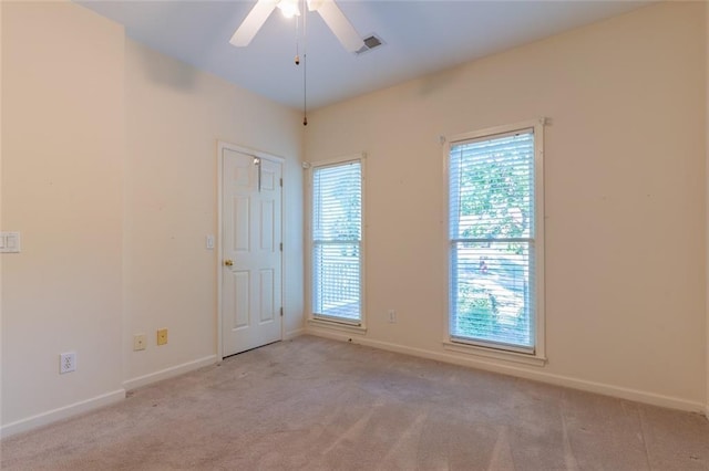 empty room featuring ceiling fan, carpet flooring, and baseboards
