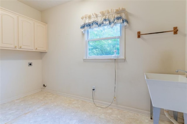 laundry area with cabinet space, electric dryer hookup, and baseboards