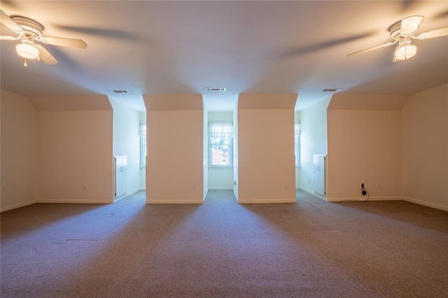 additional living space with ceiling fan, carpet floors, baseboards, and lofted ceiling