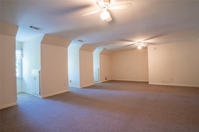 additional living space with ceiling fan, carpet flooring, and baseboards