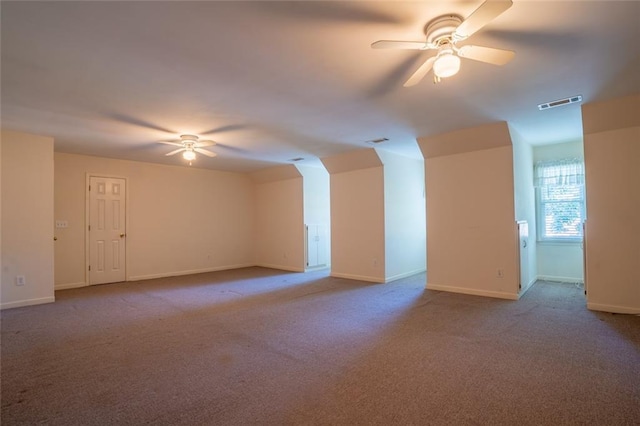 additional living space featuring ceiling fan, carpet floors, and baseboards