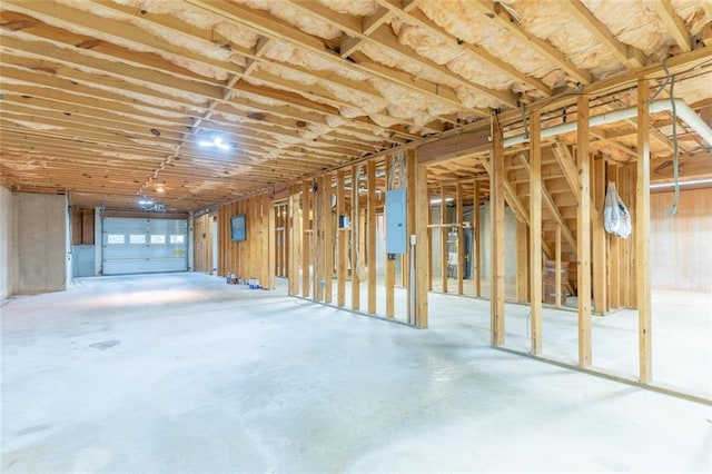 miscellaneous room with electric panel and concrete flooring