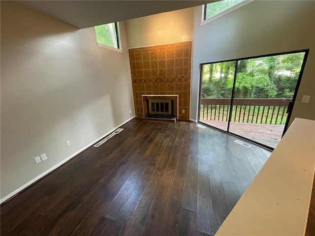 2449 Terrace Trl, Decatur, GA 30035 - unfurnished living room featuring hardwood / wood-style flooring, a tiled fireplace, and baseboards