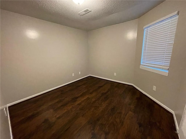 2449 Terrace Trl, Decatur, GA 30035 - unfurnished room featuring dark wood-type flooring, a textured ceiling, and baseboards