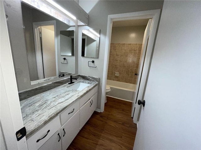 2449 Terrace Trl, Decatur, GA 30035 - bathroom with toilet, vanity, wood finished floors, and washtub / shower combination