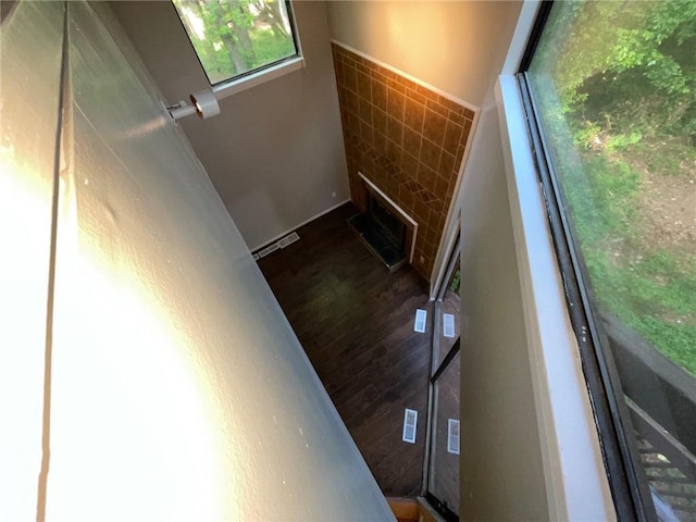 2449 Terrace Trl, Decatur, GA 30035 - stairs featuring a stone fireplace, tile walls, and wood finished floors