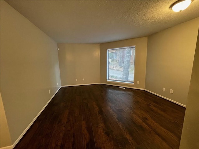 2449 Terrace Trl, Decatur, GA 30035 - spare room featuring dark wood-type flooring, baseboards, and a textured ceiling