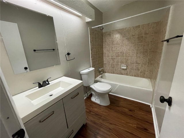2449 Terrace Trl, Decatur, GA 30035 - full bathroom with wood finished floors, washtub / shower combination, toilet, and vanity