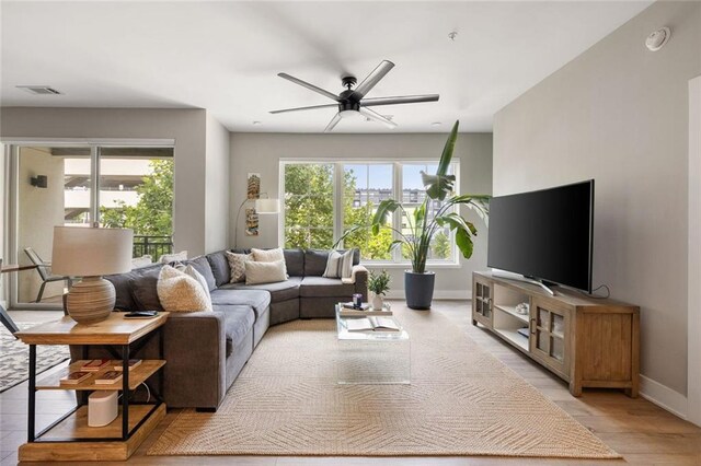 22 Airline St NE Unit 201, Atlanta, GA 30312 - living room with a ceiling fan, baseboards, and light wood-type flooring