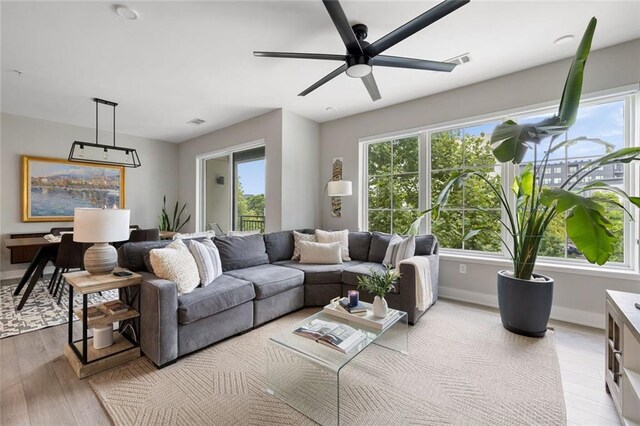 22 Airline St NE Unit 201, Atlanta, GA 30312 - living room with light wood-style flooring, plenty of natural light, a ceiling fan, and baseboards