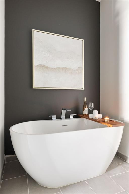 22 Airline St NE Unit 201, Atlanta, GA 30312 - full bathroom featuring tile patterned flooring, a soaking tub, and baseboards