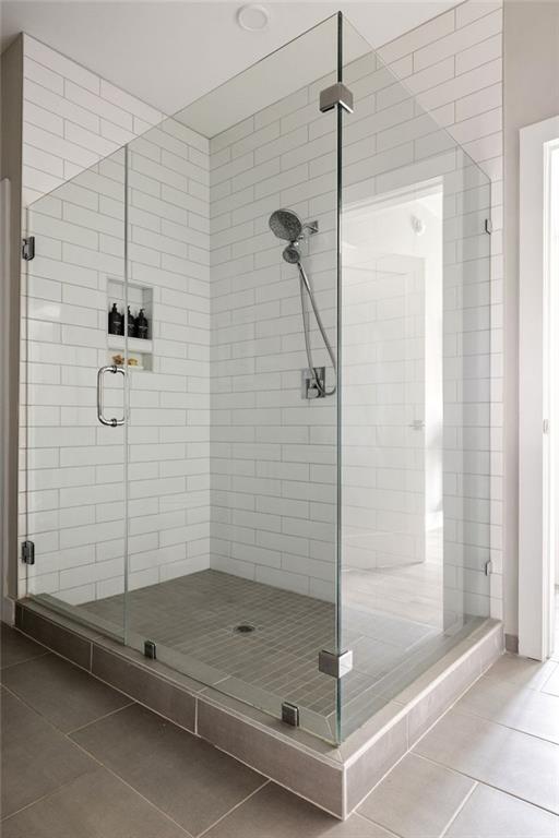 22 Airline St NE Unit 201, Atlanta, GA 30312 - bathroom featuring tile patterned flooring and a shower stall