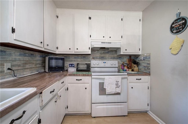 kitchen with white range with electric stovetop, under cabinet range hood, decorative backsplash, and white cabinetry