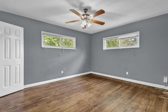 1911 Rosewood Rd, Decatur, GA 30032 - empty room with baseboards, dark wood-type flooring, a ceiling fan, and a textured ceiling