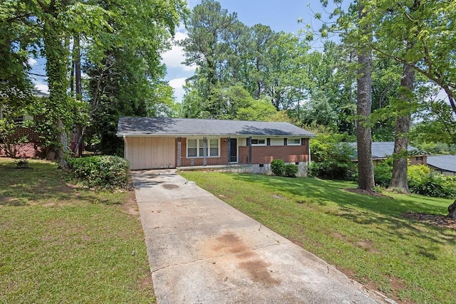 1911 Rosewood Rd, Decatur, GA 30032 - view of front facade with driveway, a front yard, crawl space, and brick siding