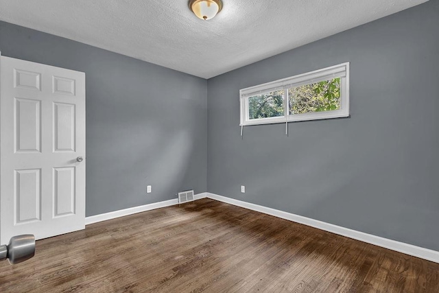 1911 Rosewood Rd, Decatur, GA 30032 - unfurnished room with baseboards, wood finished floors, and a textured ceiling