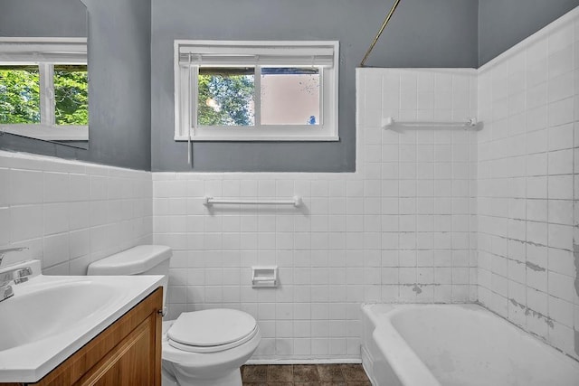 1911 Rosewood Rd, Decatur, GA 30032 - bathroom featuring tile walls, toilet, vanity, wainscoting, and tile patterned flooring