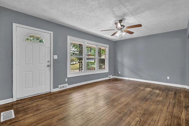 1911 Rosewood Rd, Decatur, GA 30032 - foyer featuring a ceiling fan, healthy amount of natural light, a textured ceiling, dark wood-type flooring, and baseboards