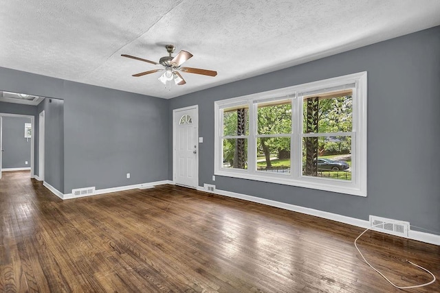 1911 Rosewood Rd, Decatur, GA 30032 - unfurnished room with a textured ceiling, ceiling fan, baseboards, and dark wood-style flooring