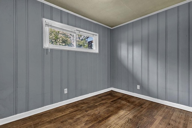 1911 Rosewood Rd, Decatur, GA 30032 - empty room with dark wood finished floors, ornamental molding, baseboards, a decorative wall, and a textured ceiling