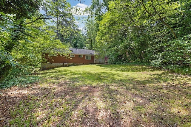 1911 Rosewood Rd, Decatur, GA 30032 - view of green lawn with a wooded view