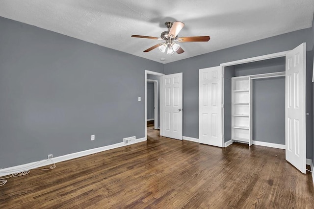1911 Rosewood Rd, Decatur, GA 30032 - unfurnished bedroom with baseboards, dark wood-style flooring, a ceiling fan, and a closet