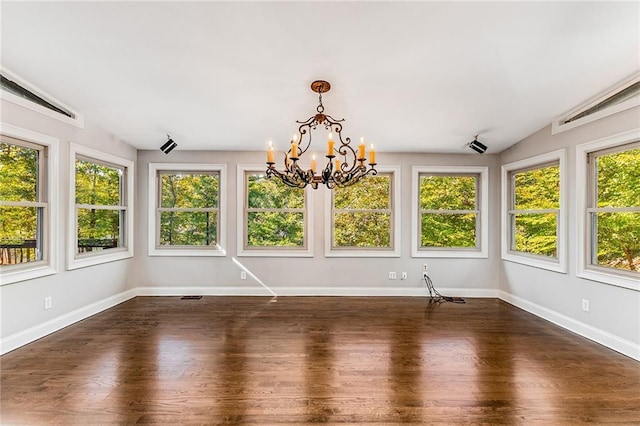 unfurnished sunroom with a chandelier and vaulted ceiling