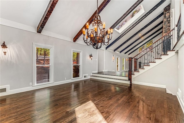 unfurnished living room featuring lofted ceiling with beams, hardwood / wood-style floors, and an inviting chandelier