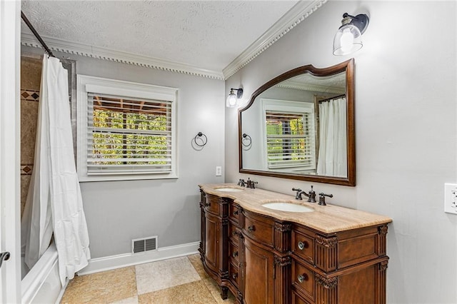 bathroom featuring crown molding, a healthy amount of sunlight, and a textured ceiling