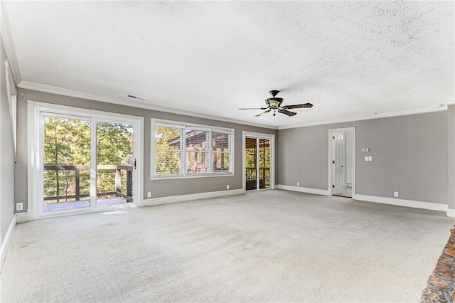 unfurnished living room featuring crown molding, a healthy amount of sunlight, carpet flooring, and a textured ceiling