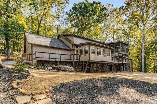 rear view of house featuring a deck and a sunroom