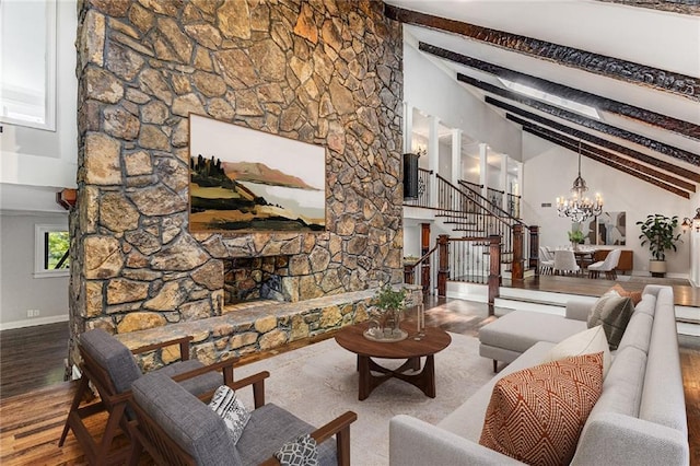 living room with an inviting chandelier, wood-type flooring, beam ceiling, and high vaulted ceiling