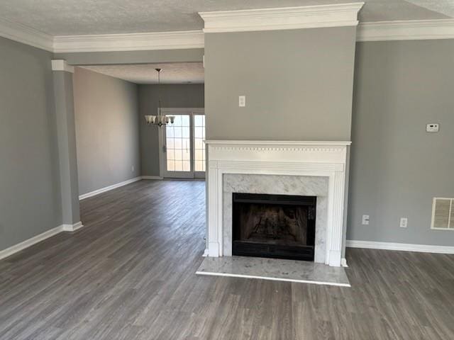 unfurnished living room featuring baseboards, wood finished floors, crown molding, and a high end fireplace