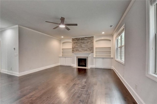 unfurnished living room featuring dark wood-type flooring, ornamental molding, ceiling fan, and visible vents
