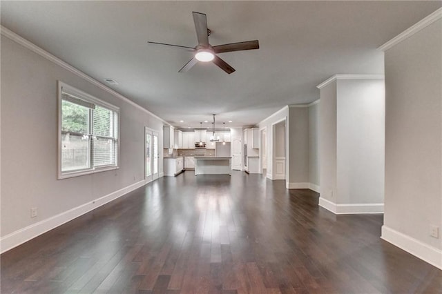 unfurnished living room with ornamental molding, a ceiling fan, baseboards, visible vents, and dark wood-style floors