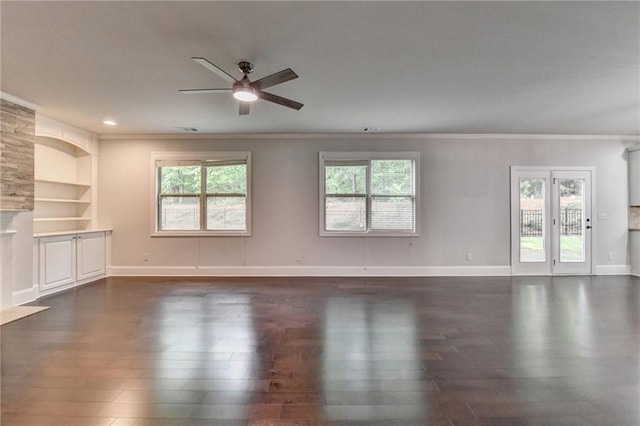 unfurnished living room with a healthy amount of sunlight, ceiling fan, and dark wood-style flooring