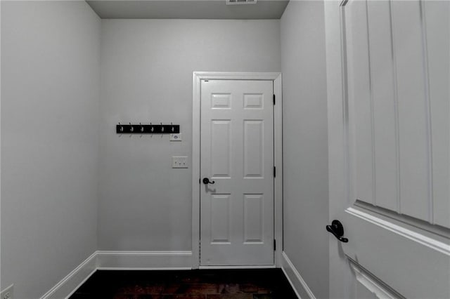 doorway featuring baseboards and visible vents