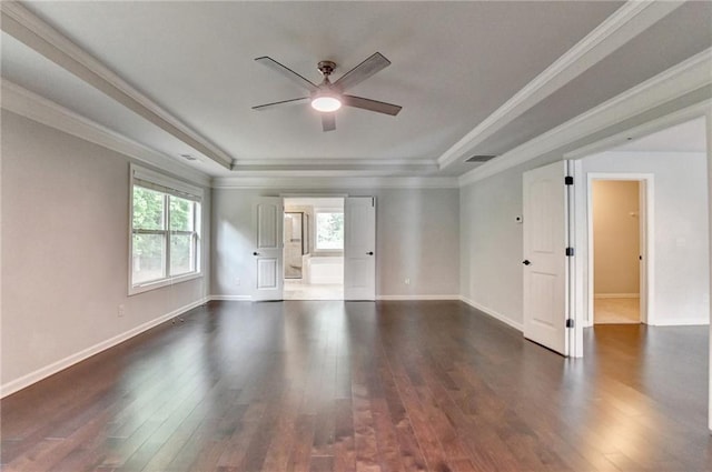 unfurnished room featuring a raised ceiling, ceiling fan, baseboards, and dark wood-style floors