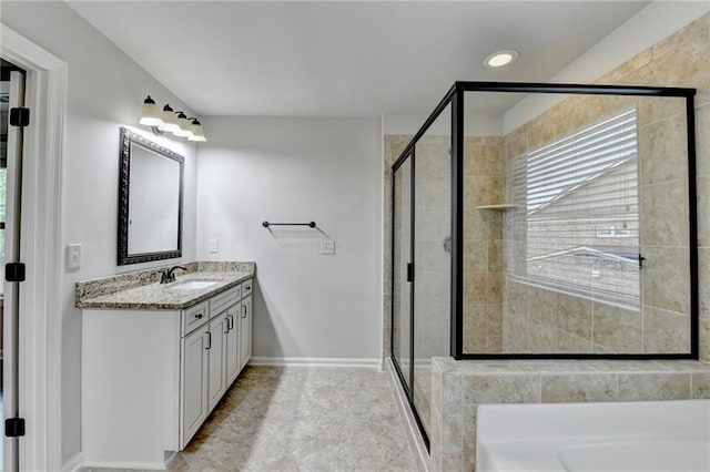 full bathroom featuring tile patterned flooring, vanity, baseboards, a bath, and a shower stall