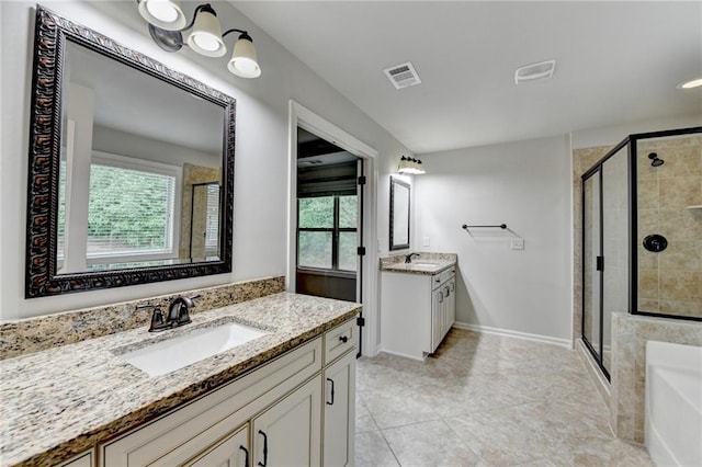 bathroom with a sink, a stall shower, and visible vents