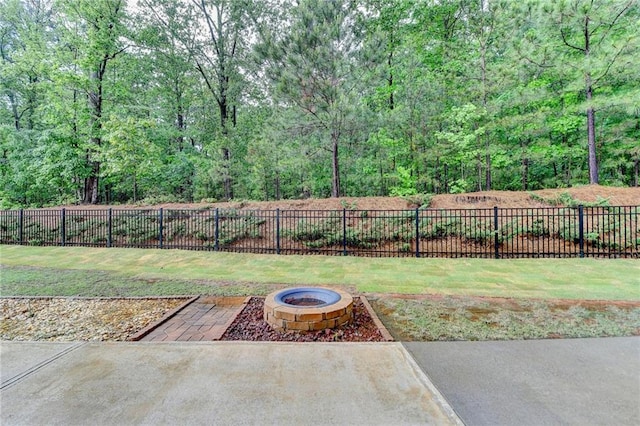 view of yard with a fenced backyard, an outdoor fire pit, and a patio area