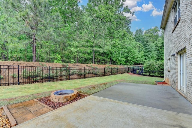 view of patio featuring a fenced backyard and an outdoor fire pit