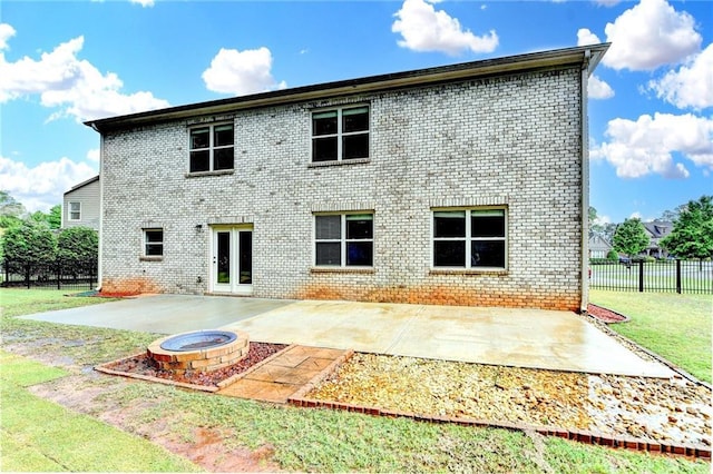 back of house with a yard, a patio, fence, and brick siding