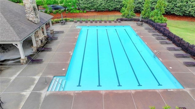 community pool featuring a patio and fence