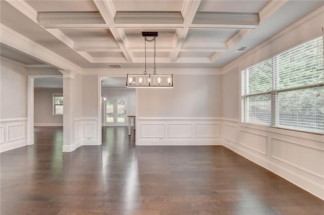 unfurnished dining area featuring plenty of natural light, dark wood-type flooring, visible vents, and beamed ceiling