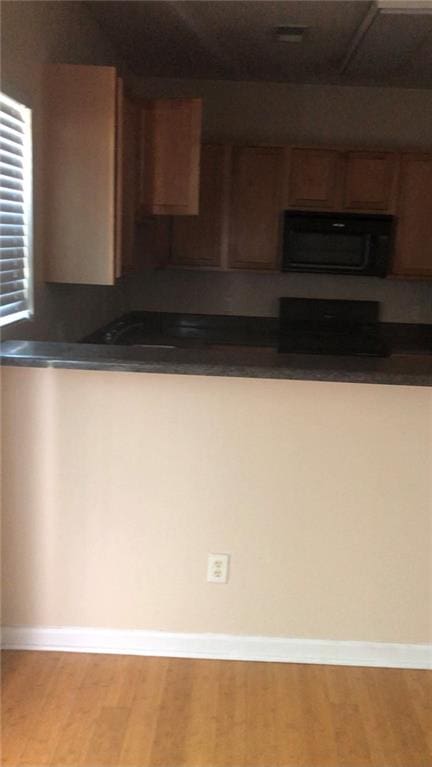 kitchen featuring stove and light wood-type flooring