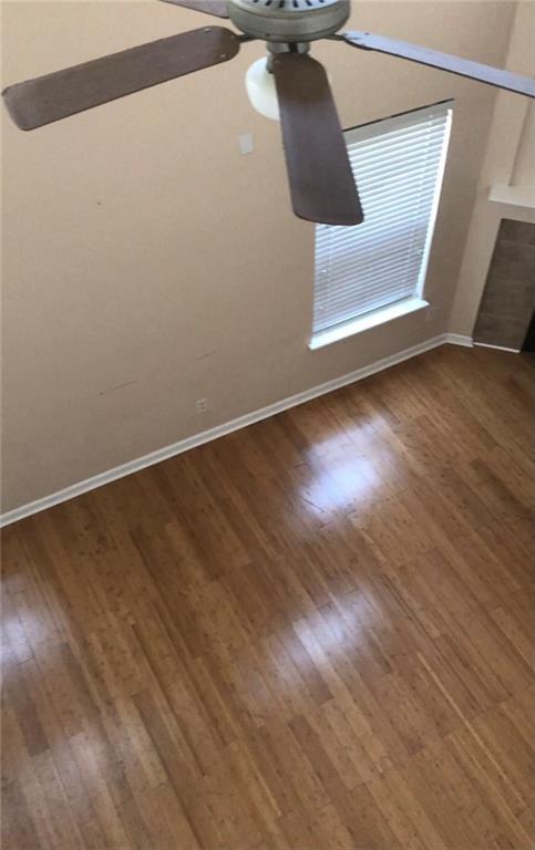 interior space featuring ceiling fan and wood-type flooring