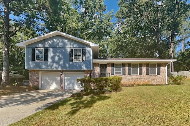 tri-level home with a garage and a front lawn